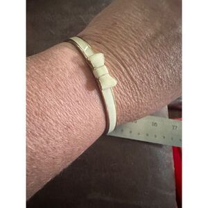Kate Spade bangle bracelet white enamel, bow gold tone